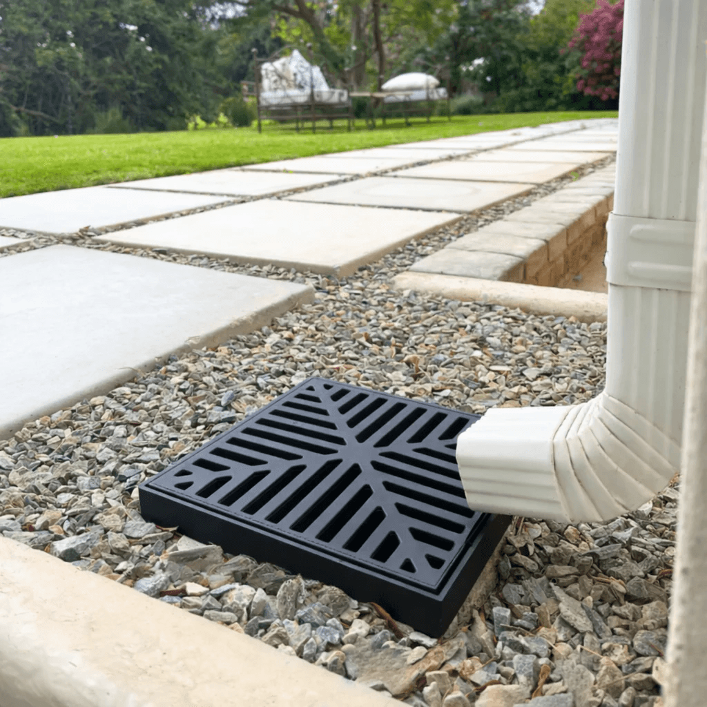 Outside gully grate beside a downpipe