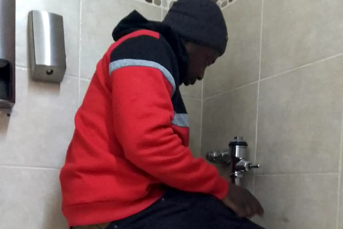 Sniper Plumbing technician repairing a toilet flush valve